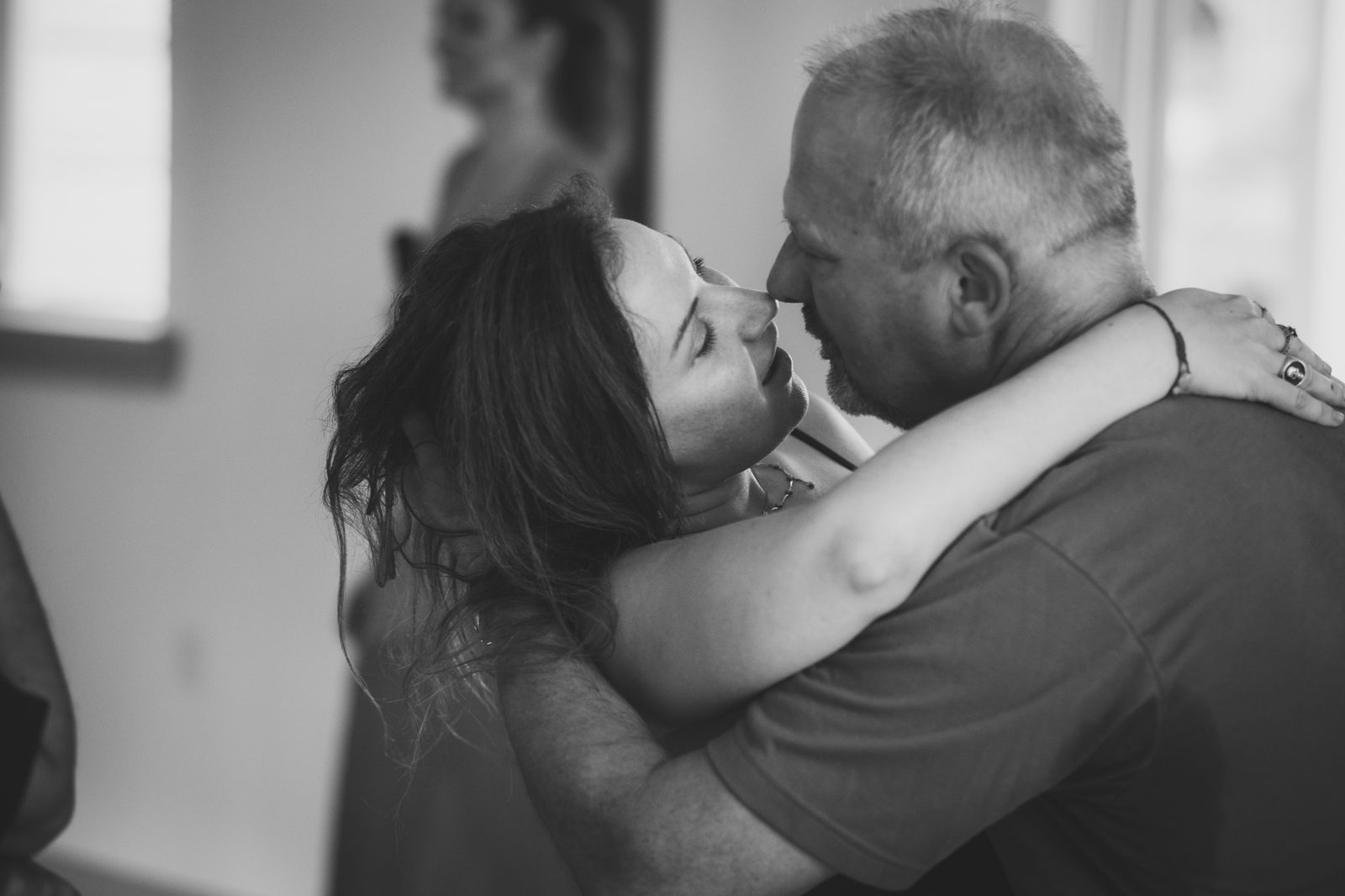 Alternate: older couple embrace black-and-white